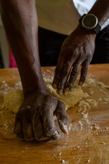 hands of a man kneading dough