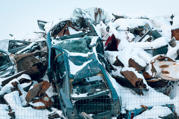 Junkyard with scrap metal and damaged cars