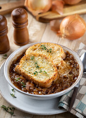 French onion soup with toasted cheese baguette garnished with thyme