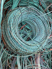 Coil of copper wire with green Verdigris oxidisation ready for recycling 