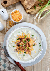 Cream of potato soup with bacon, cheese and green onions