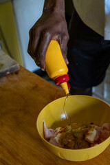 person squeezing oil from a bottle