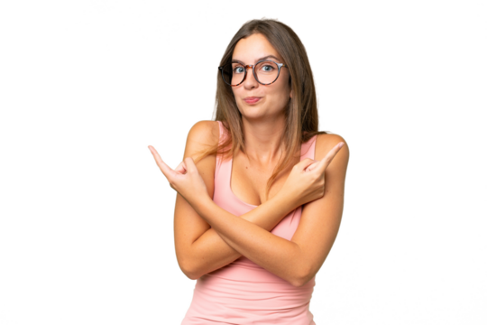 Young pretty woman over isolated background pointing to the laterals having doubts - Powered by Adobe