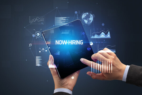 Businessman holding a foldable smartphone, business concept