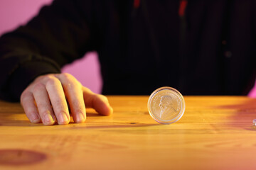 a silver krugerrand on a table with a yellow light