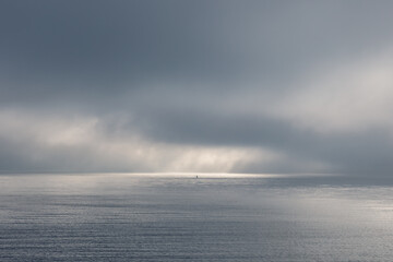 Fog clouds low above the calm water of the Irish Sea. 