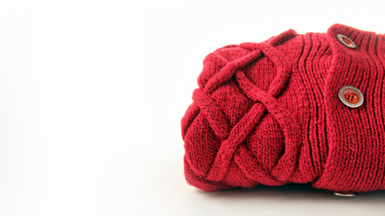 crimson wool knitted sweater with pigtail pattern, isolated on white background, copy space