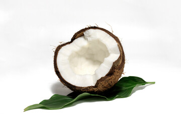 Coconut with half and leaves on white background