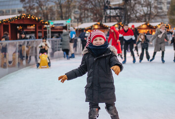 Boy skating on a rink at the Christmas market