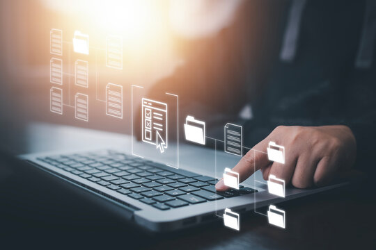 Businessman working on laptop with virtual screen. Online documentation database, IT consultant being set up Virtual Document Management System with laptop,Software for archiving corporate files.