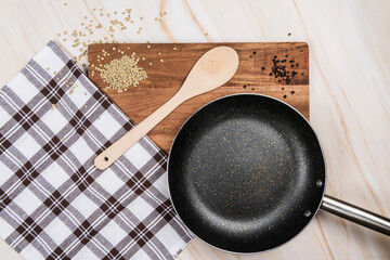 lentils and black pepper with frying pan and wooden spoon on wooden table over marble background