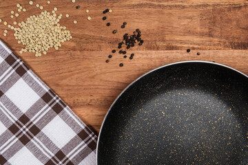 lentils and black pepper with frying pan on wood table