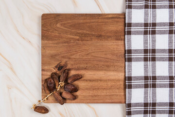 dates on wood table on marble background with checkered cloth