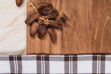 dates on wood table on marble background with checkered cloth