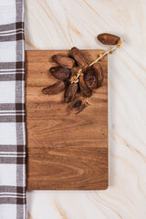 dates on wood table on marble background with checkered cloth