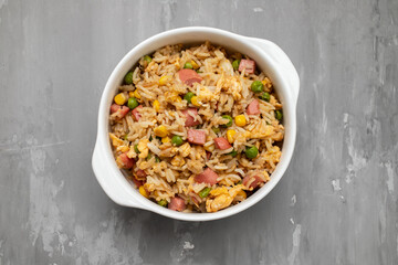 Rice with corn. peas, ham on white bowl