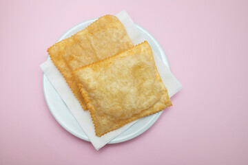 typical brazilian fried pastry on white plate