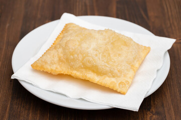 typical brazilian fried pastry on white plate