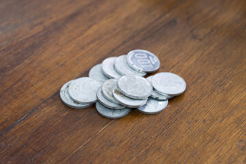 Indonesian rupiah coins money put on wooden background for poverty or crisis concept