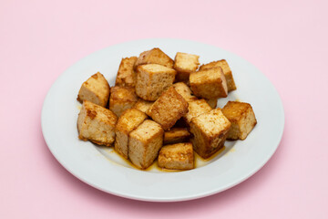 crispy deep stir fried tofu cubes on small dish