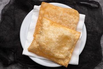 typical brazilian fried pastry on white plate