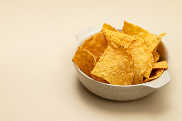 Few mexican nachos chips in small bowl