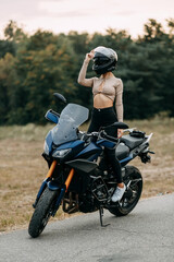 Biker girl in a helmet on a motorcycle