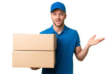 Delivery caucasian man over isolated background with shocked facial expression
