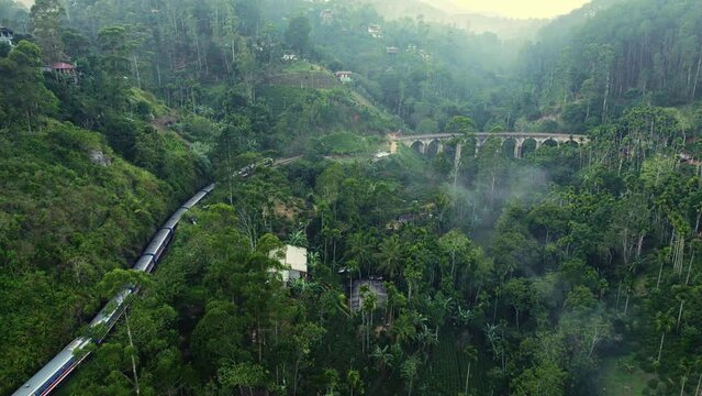 Aerial view of a train riding at dawn over the Nine Arches Bridge