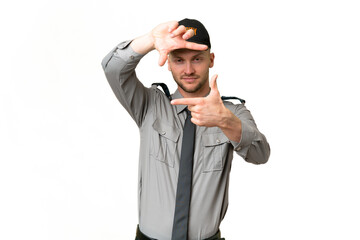 Young security caucasian man over isolated background focusing face. Framing symbol