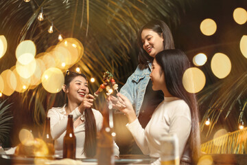 Asian woman group happy dinner barbecue party outdoor. Friendship and celebration concept.