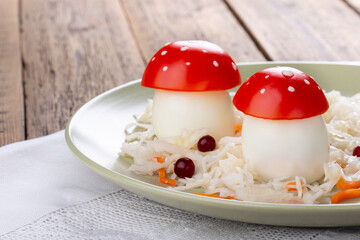 Fly agaric mushrooms made from boiled eggs, tomato and mayonnaise, served with sauerkraut.