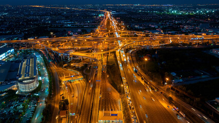 Fototapeta na wymiar Aerial view of traffic on massive highway intersection at night.