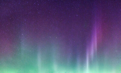 Beautiful purple and green aurora borealis and starry glowing in the night sky on arctic circle