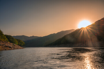 Sunset over Soyanggang Dam during cruise ship on Soyang river in the valley at Chuncheon, South Korea