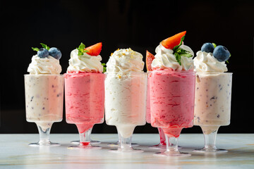 Large collection of mousse desserts in glasses for catering