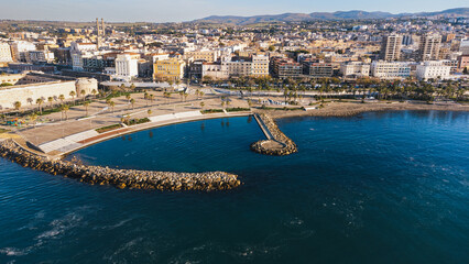 Panoramic view of the city of Civitavecchia with the adjoining tourist port and Forte Michelangelo. Emerald sea and view with tropical palm trees.