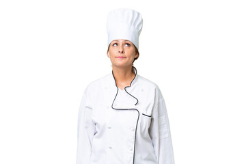 Middle-aged chef woman over isolated background and looking up