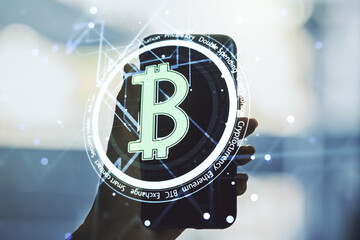 Creative Bitcoin concept and hand with phone on background. Multiexposure