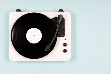 Vinyl turntable with vinyl plate on a blue background. Modern gramophone record player. Retro sound...