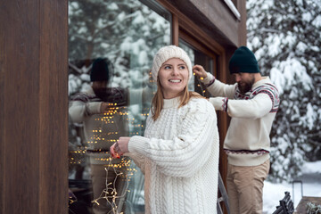 Caucasian couple decorating home for Christmas time