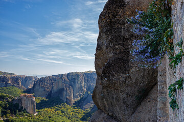 View of Meteora mountains and Roussanou monastery from the monastery of Varlaam, Greece. Travel, Greek nature, unique rock formation. Famous orthodox christian shrine, Unesco world heritage site.