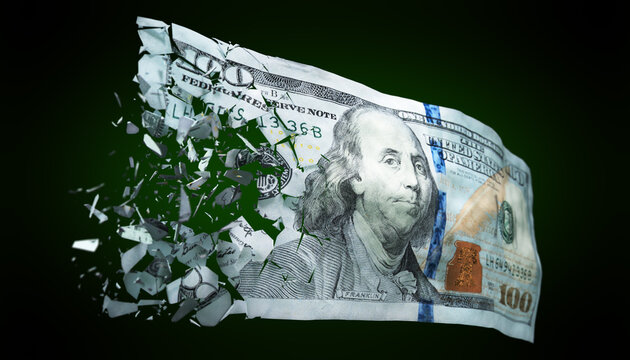 Broken US paper money on a green background