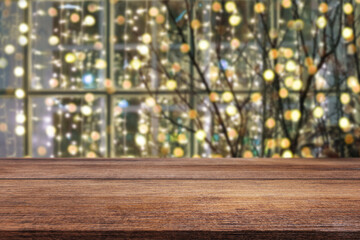 Wooden desk with New Year's or Christmas background and light bulbs. Bokeh or blur background