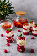 Layered dessert Trifle with vanilla cake, whipped cream and fresh raspberries