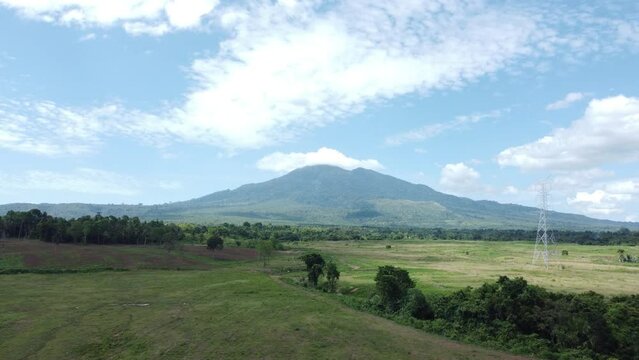 The view from the drone of Mount Seulawah Agam, green expanse of grass and trees.