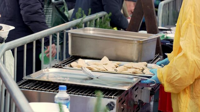 On a frosty winter day on the streets of Krakow, volunteers of the charitable organization feed everyone in need with hot meals for free, tradition of selfless help to those in need before Christmas