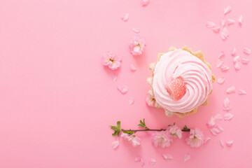 pink  cupcake with spring flowers  on pink  background