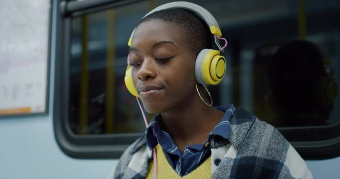 Young Black Woman With Headphones in Subway