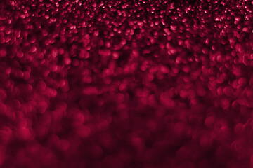 Trendy viva magenta, pink sparkling glitter bokeh background, abstract defocused texture. Holiday lights. Color of the year 2023
